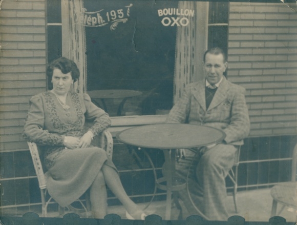 Photo of a man and woman sitting in front of a cafe, 1942