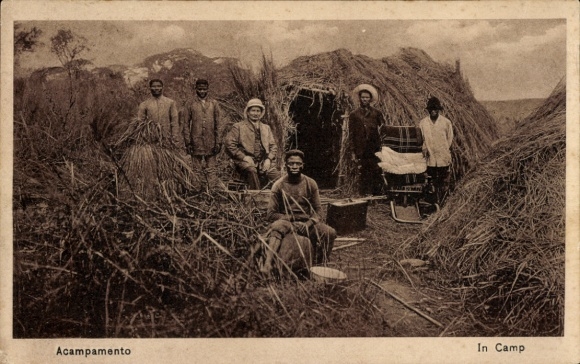 Postcard Portuguese Angola, camp, straw huts, locals and colonists