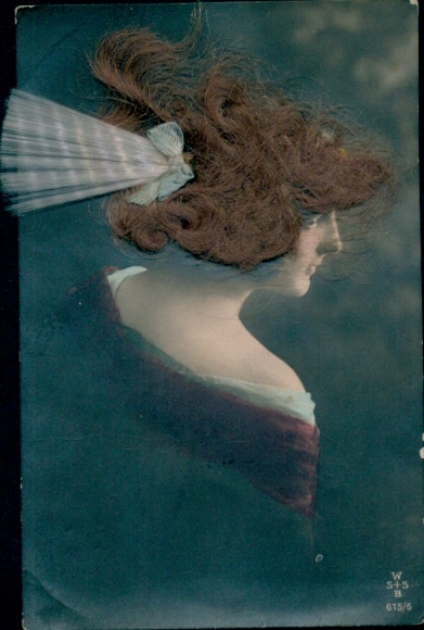 Real hair portrait of a woman with a light blue bow