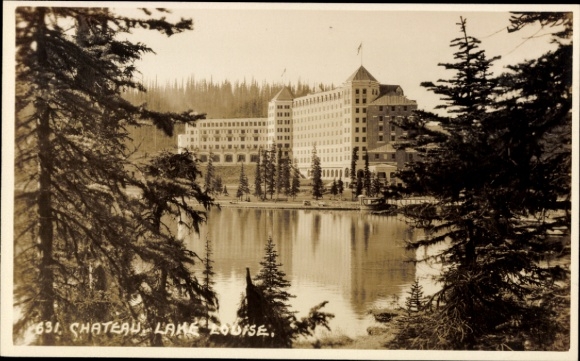 Postcard Lake Louise Alberta Canada, Chateau large hotel surrounded by trees and water
