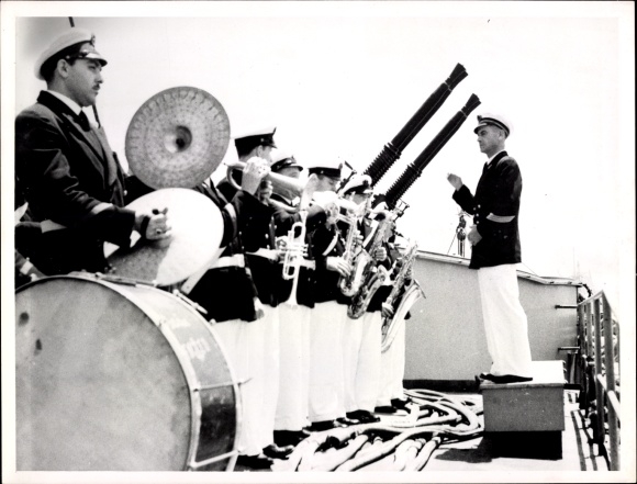 Photo of American Marines in uniform, orchestra, conductor