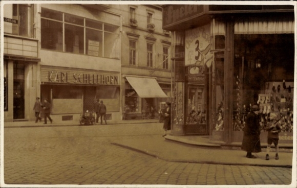 Photo Postcard street section, shop Karl Schellhorn, corner building, shop Speler?, shop window