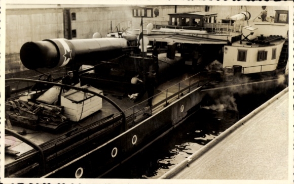 Photo of a cargo tug in the lock, with its chimney folded down.
