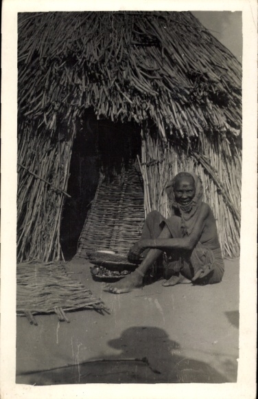 Old woman in front of hut in Chad
