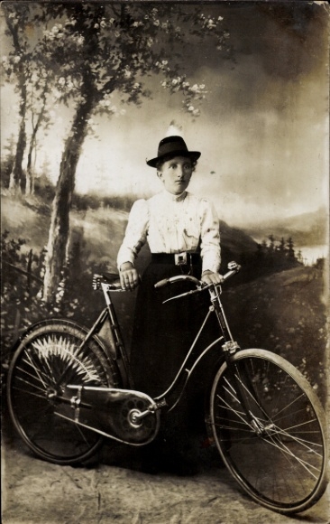 Photo Postcard woman in traditional dress with a bicycle