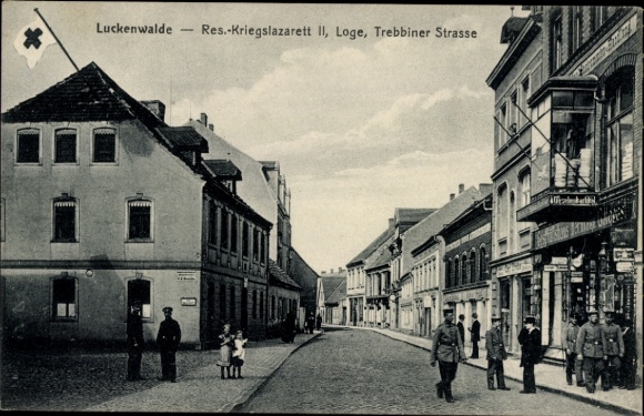 Postcard Luckenwalde in Brandenburg, Trebbiner Straße, lodge as reserve war hospital II, shops
