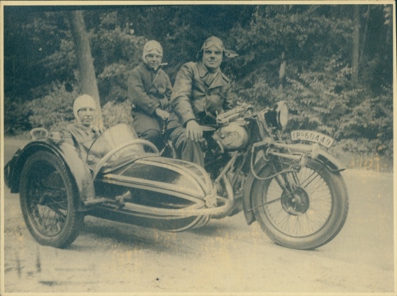 Photo of family on an NSU motorcycle with sidecar, registration number IP 50449