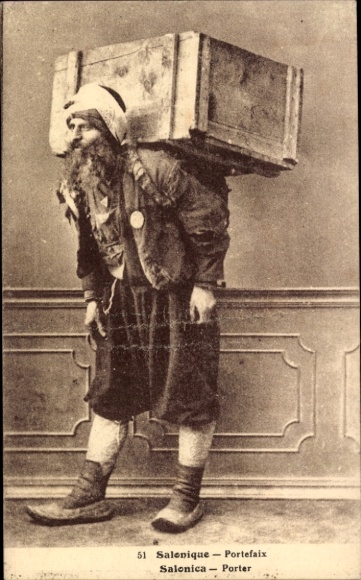 Postcard Greek porter in traditional dress, loaded