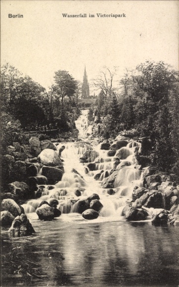 Berlin Kreuzberg, view of the waterfall in Victoriapark, church tower