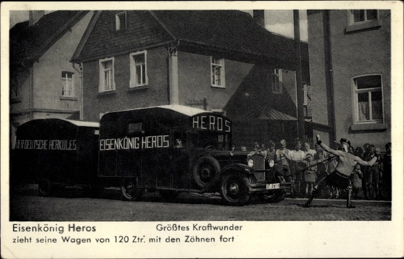 Postcard Iron King Heros pulls car with his teeth