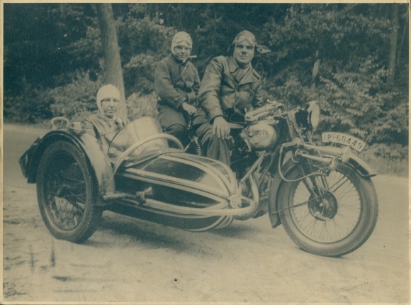 Photo of family on an NSU motorcycle with sidecar, registration number IP 50449