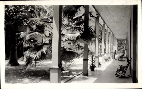 Photo Postcard Colombia, arcades on a building, rocking chair