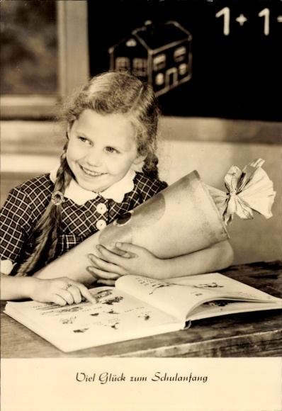 Congratulations on starting school, girl with a candy cone